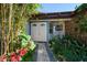 Charming front entrance with lush landscaping, a stone pathway, and a welcoming double door at 19 N Pine Cir, Belleair, FL 33756