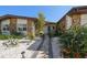 Inviting front yard with stone accents, lush landscaping, and a charming walkway to the front door at 19 N Pine Cir, Belleair, FL 33756