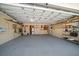 Spacious garage with organized storage shelves and ample room for parking and projects at 19 N Pine Cir, Belleair, FL 33756