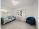 Bright living room featuring a futon, table, and comfortable seating by the windows with natural light at 19 N Pine Cir, Belleair, FL 33756