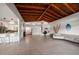 Open-concept living area with modern design, vaulted ceiling, and seamless transition to the kitchen at 19 N Pine Cir, Belleair, FL 33756