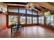 Open living room with wood-paneled walls, high ceilings, and water views through large windows at 19 N Pine Cir, Belleair, FL 33756