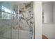 Shower with decorative tile, and glass door at 19 N Pine Cir, Belleair, FL 33756