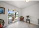 Sun room features terrazzo floors and sliding glass doors leading to a patio with a waterfront view at 19 N Pine Cir, Belleair, FL 33756