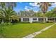 Charming single-story home with a well-manicured lawn and beautiful landscaping at 22129 Carson Dr, Land O Lakes, FL 34639