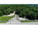 Expansive estate entrance with white brick pillars and a long, winding driveway surrounded by trees at 22129 Carson Dr, Land O Lakes, FL 34639