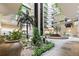 A grand lobby with a fountain, lush plants, and an elevator in a stylish interior space at 2413 Bayshore Blvd # 801, Tampa, FL 33629