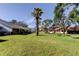 Well-manicured backyard with mature trees providing shade and privacy at 2557 Laurelwood Dr # 10E, Clearwater, FL 33763