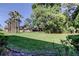Beautiful backyard with mature trees and lush lawn offering privacy at 2557 Laurelwood Dr # 10E, Clearwater, FL 33763
