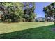 Expansive backyard with lush green lawn and mature trees, providing privacy and a serene setting at 2557 Laurelwood Dr # 10E, Clearwater, FL 33763