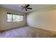 A bedroom with carpet, a ceiling fan and a large window providing ample light at 2557 Laurelwood Dr # 10E, Clearwater, FL 33763