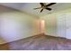 Neutral bedroom features a ceiling fan, closet and carpet at 2557 Laurelwood Dr # 10E, Clearwater, FL 33763