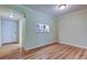 Dining space featuring wood floors and a pass-through window to the kitchen at 2557 Laurelwood Dr # 10E, Clearwater, FL 33763