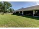 A charming home exterior features a well-manicured lawn and screened-in patio at 2557 Laurelwood Dr # 10E, Clearwater, FL 33763