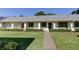 Charming single-story home featuring well-maintained landscaping and a welcoming walkway leading to the entrance at 2557 Laurelwood Dr # 10E, Clearwater, FL 33763