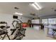 Bright community gym featuring cardio equipment, a pool table, and large windows for natural light at 2557 Laurelwood Dr # 10E, Clearwater, FL 33763