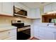 Updated kitchen showcasing stainless steel appliances, white cabinetry, and modern countertops at 2557 Laurelwood Dr # 10E, Clearwater, FL 33763