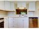 Well-lit kitchen featuring white cabinets, modern appliances, and an open design to other room at 2557 Laurelwood Dr # 10E, Clearwater, FL 33763