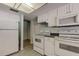 Efficient kitchen with white appliances, cabinetry, and a functional layout providing cooking convenience at 2557 Laurelwood Dr # 10E, Clearwater, FL 33763