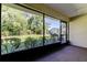 Enclosed lanai with views of the landscaped backyard and mature trees at 2557 Laurelwood Dr # 10E, Clearwater, FL 33763