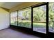 Enclosed lanai showcasing views of the lush green backyard at 2557 Laurelwood Dr # 10E, Clearwater, FL 33763