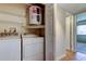 Functional laundry area with washer, dryer, shelving and water heater at 2557 Laurelwood Dr # 10E, Clearwater, FL 33763
