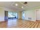 Spacious living room with modern wood flooring, recessed ceiling lighting, and a glass sliding door at 2557 Laurelwood Dr # 10E, Clearwater, FL 33763