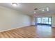 Spacious living room with wood floors and sliding glass doors leading to the lanai at 2557 Laurelwood Dr # 10E, Clearwater, FL 33763