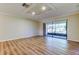Open living room features modern flooring, recessed ceiling lighting, and glass sliding doors to the outside at 2557 Laurelwood Dr # 10E, Clearwater, FL 33763