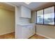 Pantry area with white cabinets, drawers, and countertops next to a window at 2557 Laurelwood Dr # 10E, Clearwater, FL 33763