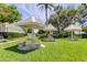 Charming picnic area with shaded tables, stone benches, and lush landscaping, perfect for outdoor dining at 2557 Laurelwood Dr # 10E, Clearwater, FL 33763