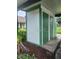 Outdoor storage shed painted white and green, with dark green doors at 2557 Laurelwood Dr # 10E, Clearwater, FL 33763