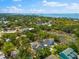 An aerial view showcasing the properties proximity to the bay, as well as the surrounding lush greenery and neighborhood at 322 Ontario Ave, Crystal Beach, FL 34681