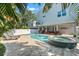 Beautiful backyard with a pool, hot tub, patio, and lounging area, ideal for outdoor entertaining at 322 Ontario Ave, Crystal Beach, FL 34681