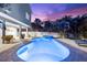 Beautiful backyard featuring a pool, hot tub, spacious patio, and tropical landscaping at 322 Ontario Ave, Crystal Beach, FL 34681