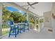 Relaxing covered balcony with comfortable seating and a great view of the neighborhood at 322 Ontario Ave, Crystal Beach, FL 34681