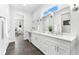 Bright bathroom with dual sinks, vanity, and access to the ensuite bedroom at 322 Ontario Ave, Crystal Beach, FL 34681