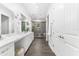 Elegant bathroom featuring a double vanity, glass shower, and contemporary fixtures at 322 Ontario Ave, Crystal Beach, FL 34681