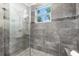 Stunning bathroom featuring glass shower doors, a tiled shower, and a built-in bench at 322 Ontario Ave, Crystal Beach, FL 34681