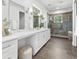 Elegant bathroom featuring a double vanity, glass shower, and contemporary fixtures at 322 Ontario Ave, Crystal Beach, FL 34681