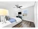 Comfortable secondary bedroom features a ceiling fan, light and window with blinds at 322 Ontario Ave, Crystal Beach, FL 34681