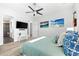 Bright bedroom with wood floors, ensuite bathroom, modern dresser and ceiling fan at 322 Ontario Ave, Crystal Beach, FL 34681