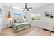 Inviting bedroom boasts a ceiling fan, wood floors, neutral tones, and bright natural light at 322 Ontario Ave, Crystal Beach, FL 34681