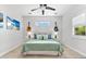Inviting bedroom boasts a ceiling fan, wood floors, neutral tones, and bright natural light at 322 Ontario Ave, Crystal Beach, FL 34681