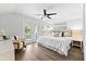 This primary bedroom is well-lit with a calming wall art and private balcony at 322 Ontario Ave, Crystal Beach, FL 34681