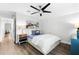 Comfortable secondary bedroom features a ceiling fan, light and artwork at 322 Ontario Ave, Crystal Beach, FL 34681