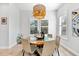 Bright dining room with a unique round table and modern light fixture at 322 Ontario Ave, Crystal Beach, FL 34681