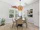 Charming dining area with a unique round table and modern light fixture at 322 Ontario Ave, Crystal Beach, FL 34681