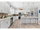 Bright kitchen featuring a center island, white cabinetry, and stainless steel appliances at 322 Ontario Ave, Crystal Beach, FL 34681