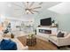 Open-concept living room features a fireplace, modern ceiling fan, and seamless flow to the kitchen at 322 Ontario Ave, Crystal Beach, FL 34681